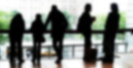 Silhouette Of Five De-focused People Standing In Different Poses, Reflecting In The Floor